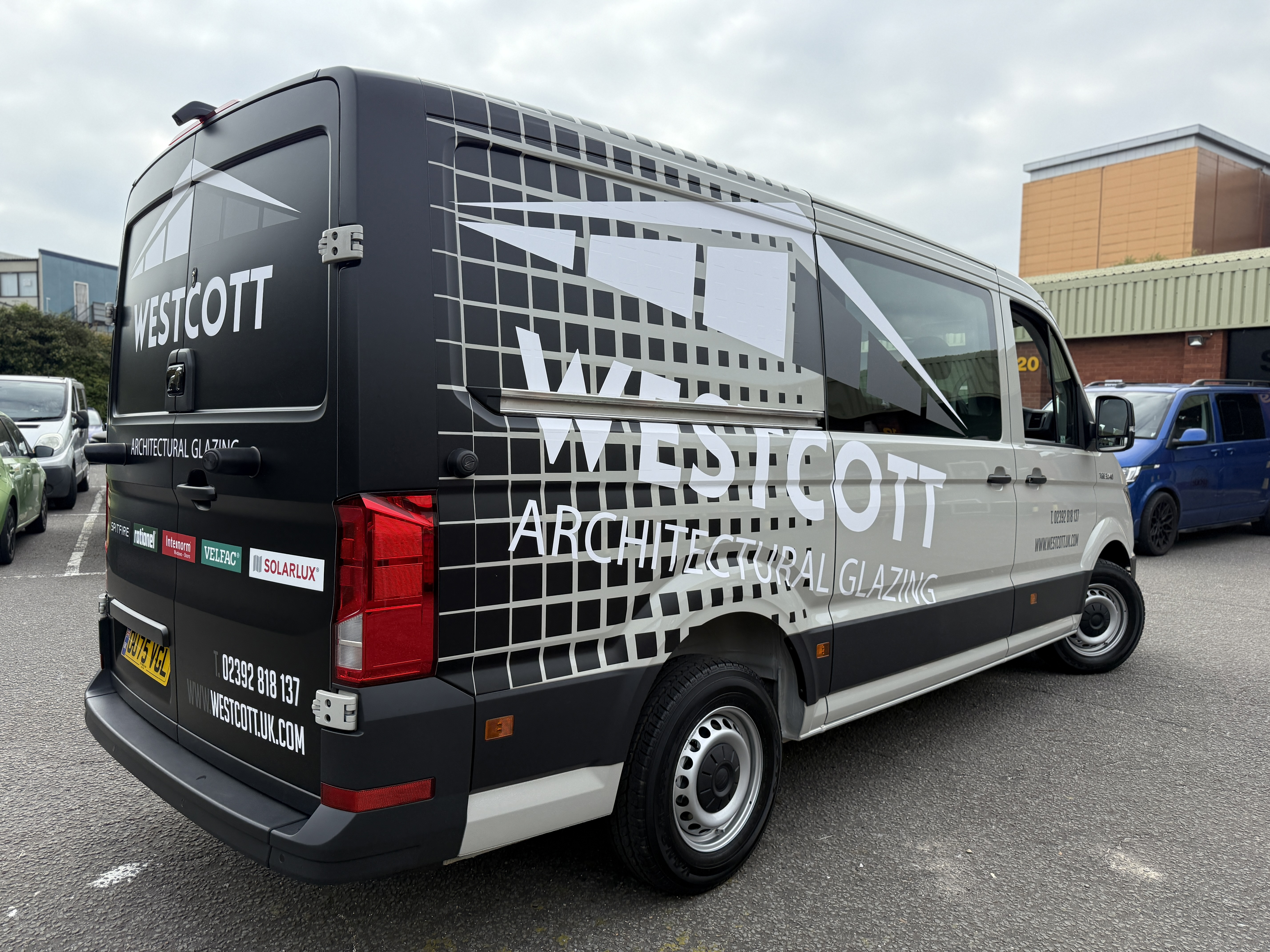 Professional installation of commercial vehicle wrapping by Sticky Media technicians. 